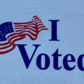 I Voted sticker with an American Flag