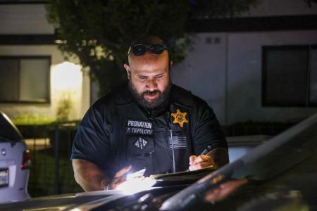 Probation Officer outside filling paperwork
